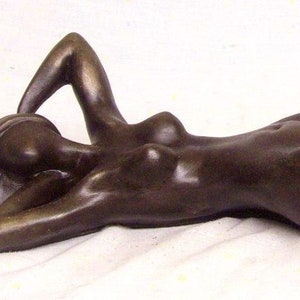 Cold cast Bronze sculpture woman lying on the floor.