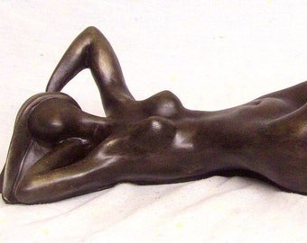 Cold cast Bronze sculpture woman lying on the floor.