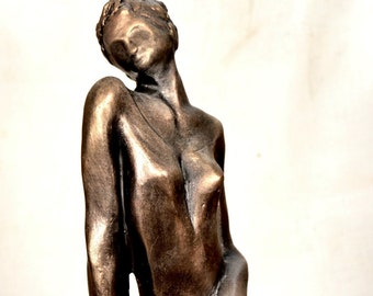 Modern art decor  sculpture, woman seated on a pedestal