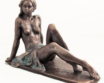 Beautiful sculpture,  woman seated on plinth