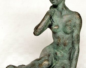 Statuette young woman seated on floor, with hand on shoulder,  green patina