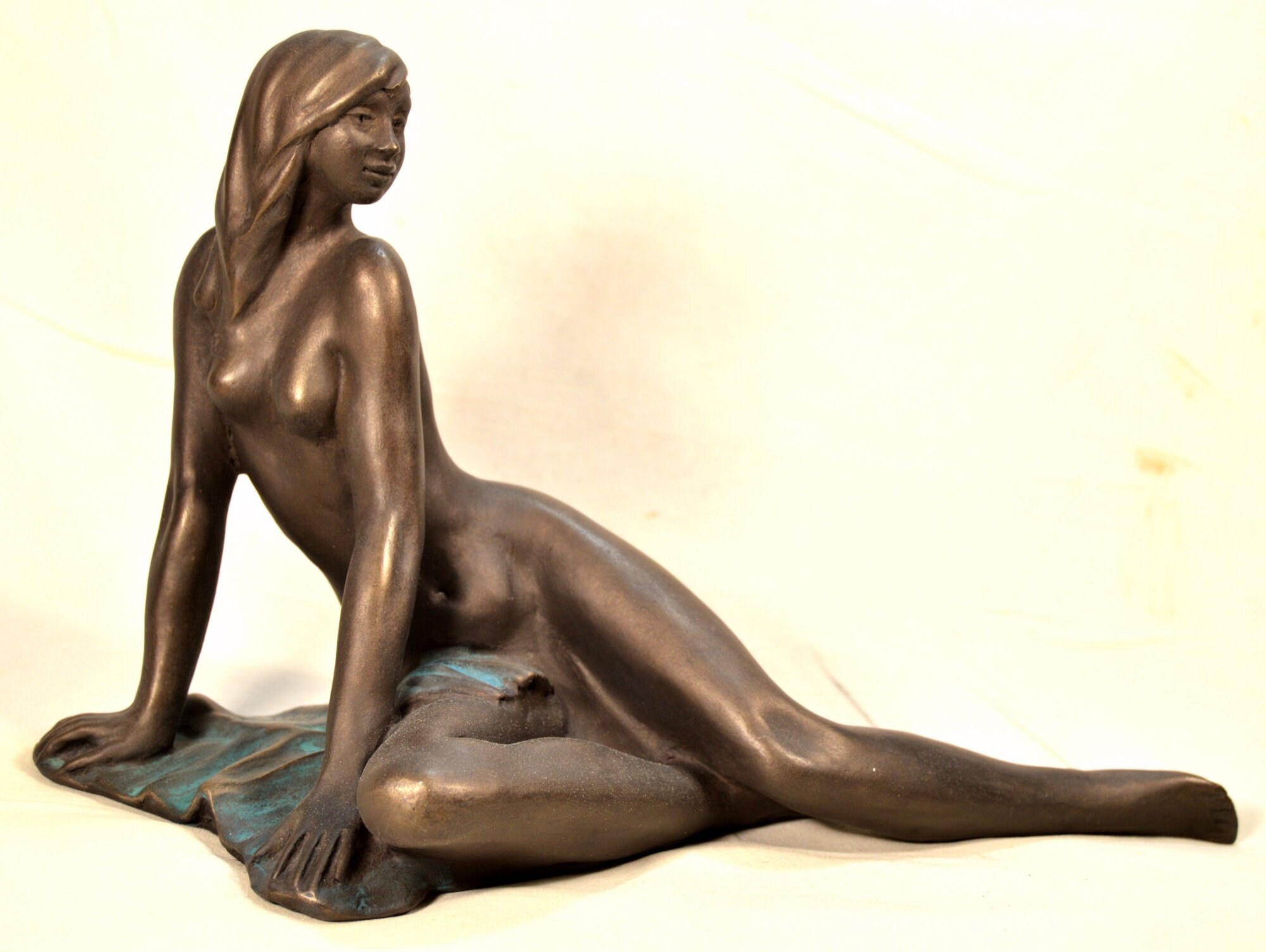 Cold cast  Bronze sculpture, woman lying on cloth