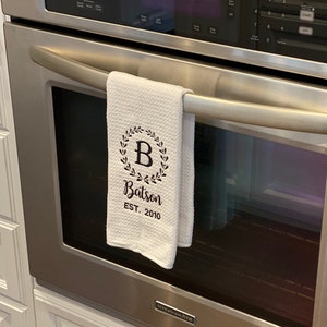 Wreath style design on a white waffle kitchen towel.