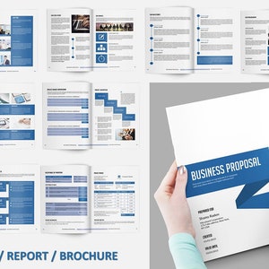 May include: A business proposal brochure with a blue banner and the words "BUSINESS PROPOSAL". The brochure is held by a person. The brochure has a white background with blue accents. The image also shows other brochure pages.