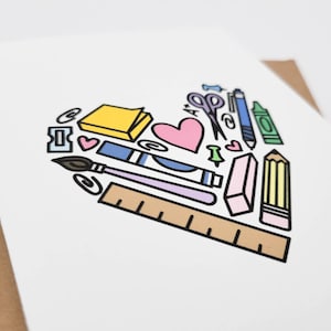 May include: A white card with a heart-shaped design made up of various school supplies, including a pencil, ruler, eraser, scissors, paintbrush, glue stick, paper clips, push pins, and a sticky note. The heart is outlined in black and filled with various colors, including pink, blue, yellow, green, and brown.