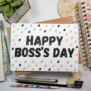 May include: A white card with a colorful confetti pattern and the text "Happy Boss's Day" in black.