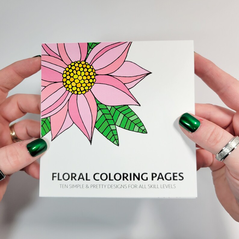 May include: A pink and green floral colouring page with the text "Floral Coloring Pages" and "Ten simple & pretty designs for all skill levels".