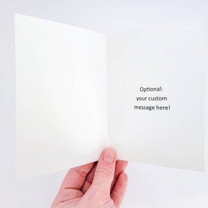 May include: Blank white card with a folded edge. The inside of the card has the text "Optional: your custom message here!" printed in black.