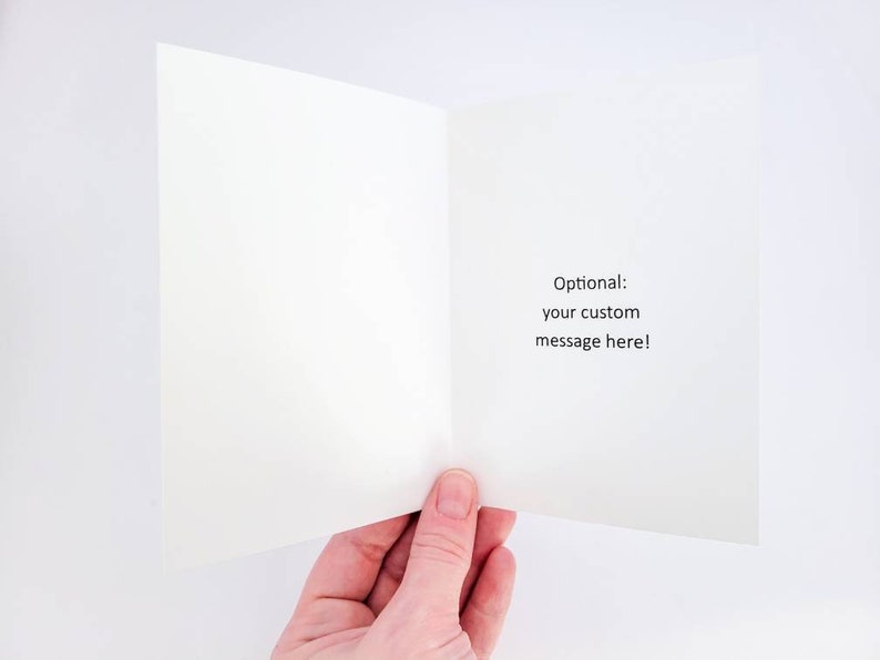 May include: Blank white card with a folded edge. The inside of the card has the text "Optional: your custom message here!" printed in black.
