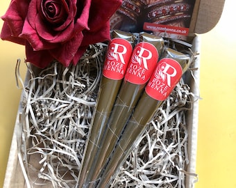 May include: Three brown henna cones with red labels that say "Roze Henna" in a cardboard box with shredded paper and a red rose.