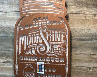 May include: A metal cutout of a mason jar with the words "Old Fashioned Moonshine Corn Liquor 110 Proof" and a remote control for the LED lights.