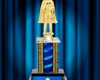 May include: A gold trophy with a king figure holding a scepter, standing on a blue and gold base with the words "FOREVER MY KING" on the front.