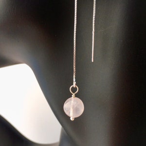 May include: A pair of silver chain earrings with a pink rose quartz bead on each chain.