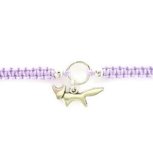 May include: A purple braided friendship bracelet with a silver fox charm.