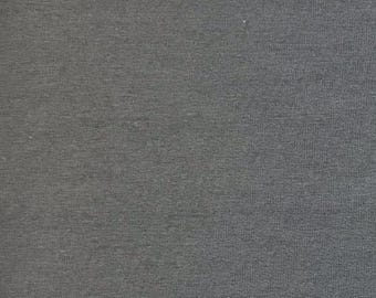 May include: A close-up of a gray, textured fabric. The fabric has a subtle woven pattern.
