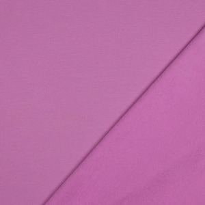 May include: A close-up of two sections of pink fabric. One section has a ribbed texture, while the other is smooth. The fabric is a solid, light pink color, and the two sections are divided diagonally.