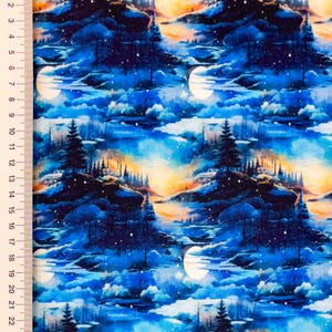 May include: Fabric with a repeating pattern of a nighttime landscape. The design features dark blue mountains, evergreen trees, a full moon, and a sky with shades of blue, orange, and yellow. The fabric has a painterly style.