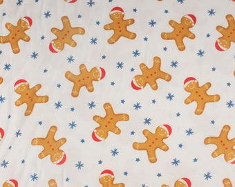 Gingerbread Man on Ivory Double Brushed Poly.  Sold by the 1/2 yard