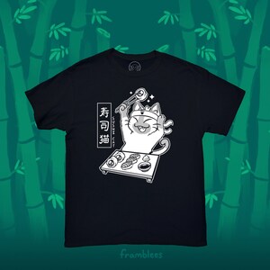 May include: Black t-shirt with a white graphic of a cat wearing a headband and holding chopsticks with a sushi roll. The text "Sushi Cat" and "寿司猫" are written in Japanese on the shirt.