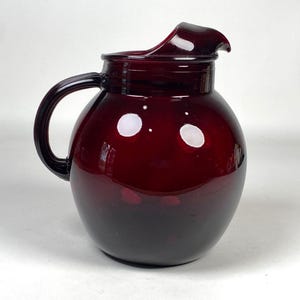 May include: A rustic wooden sign with the text "Welcome to our home" in white lettering. The sign features a distressed finish and a simple, inviting design, perfect for front door decor.