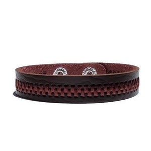 May include: A brown leather bracelet with a woven design and silver metal accents.