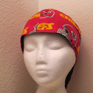 May include: Red and yellow fabric welding cap with the Kansas City Chiefs logo and the word "Chiefs" repeated on the fabric.