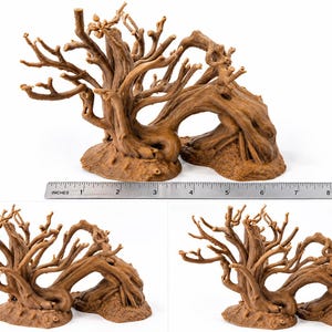 May include: A brown, textured tree-like sculpture with multiple branches and a hollow archway base. A metal ruler is positioned in front, showing the object spans approximately 9 inches in width. The structure features a gnarled, organic appearance.