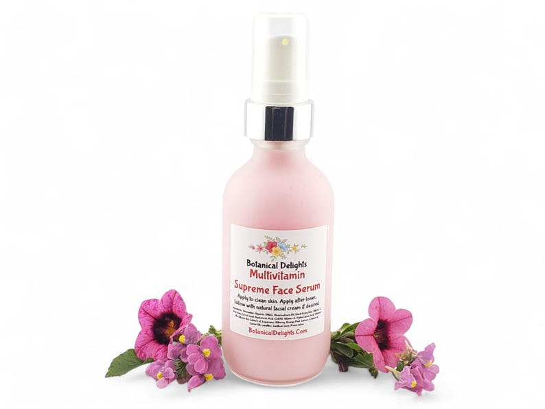 a bottle of liquid sitting next to a flower