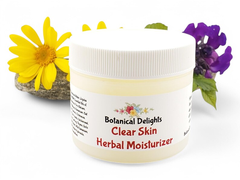 a jar of clear skin herb moistizer next to a flower