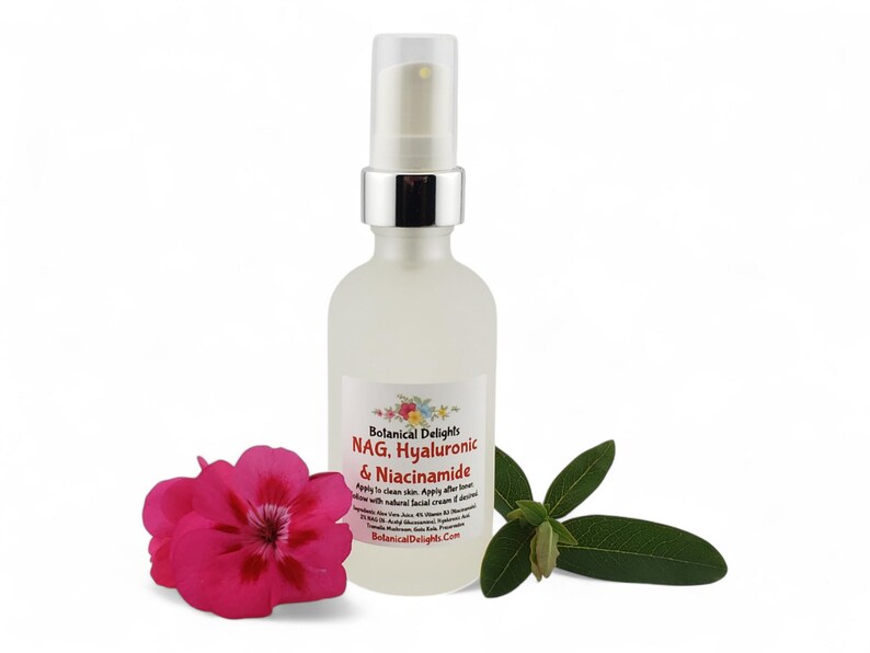 May include: A frosted glass bottle with a silver pump top, labeled "Botanical Delights NAG, Hyaluronic & Niacinamide." A pink flower and green leaves are next to the bottle. The bottle contains a clear liquid.