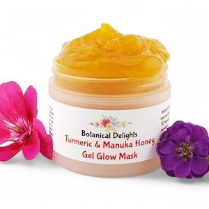 May include: A clear jar with a yellow gel face mask inside. The jar has a white label with the text "Botanical Delights Turmeric & Manuka Honey Gel Glow Mask".