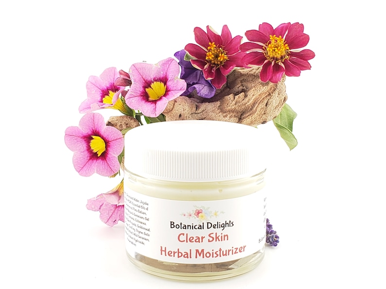 a jar of clear skin facial moister next to flowers