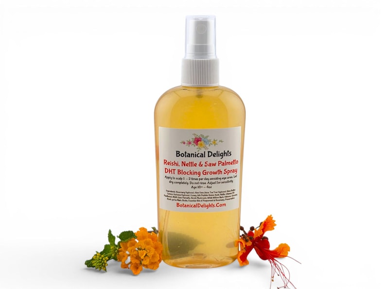 a bottle of Botanical Delights Reishi Nettle & Saw Palmetto Growth Spray surrounded by orange flowers.