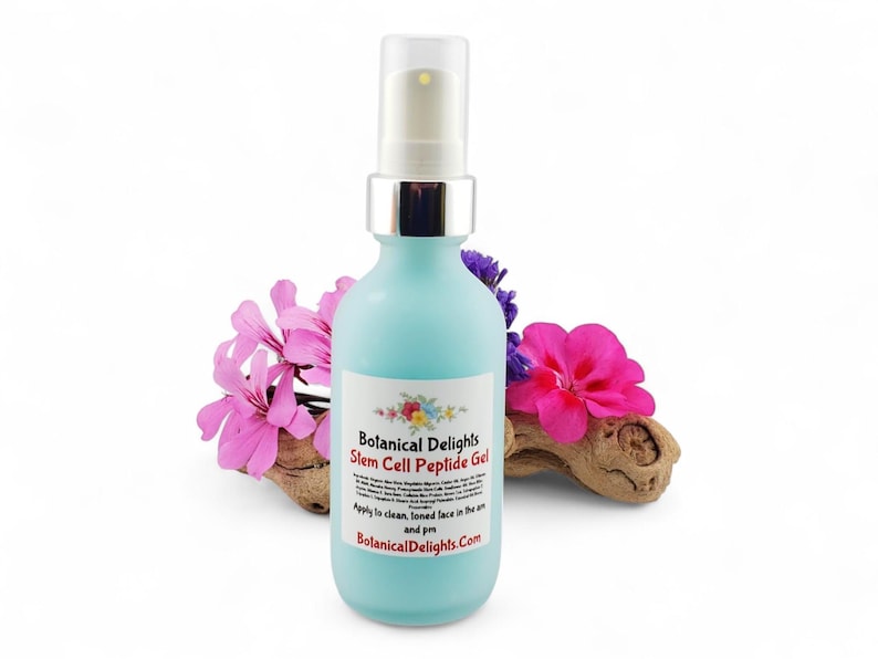 May include: A light blue bottle of Botanical Delights Stem Cell Peptide Gel with a silver cap and pump. The bottle is surrounded by pink and purple flowers and a piece of wood. The label includes the brand name and product details.