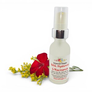 May include: A frosted glass bottle with a silver pump top, labeled "Botanical Delights NAG, Hyaluronic & Niacinamide." A red flower and yellow sprigs are next to the bottle, suggesting a natural skincare product.