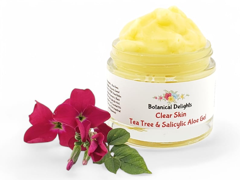 a jar of clear skin tea tree and salic aloene next to a