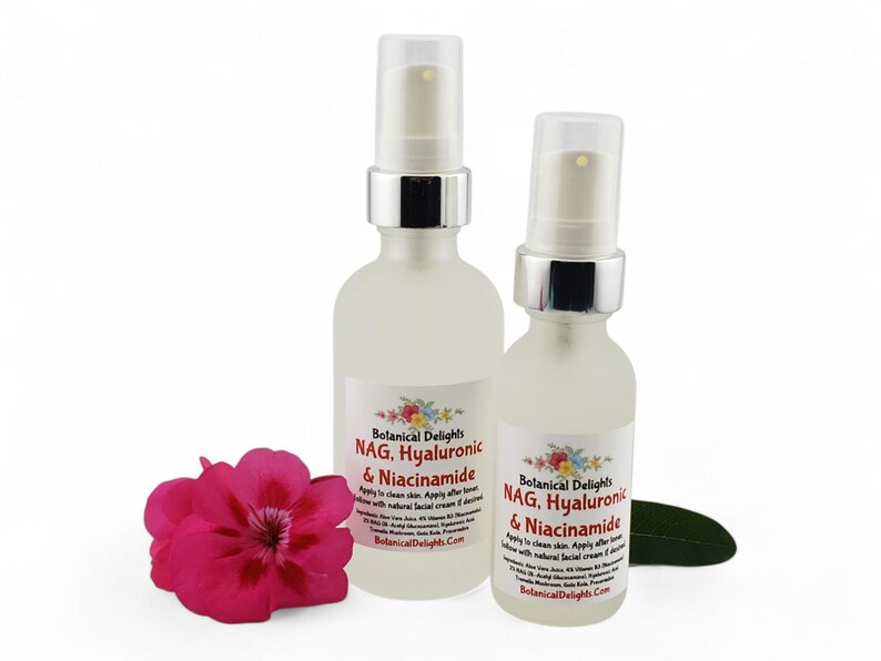 May include: Two frosted glass spray bottles with silver tops, labeled "Botanical Delights NAG, Hyaluronic & Niacinamide." A bright pink flower and a green leaf are in the foreground. The bottles are for skincare.