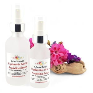 a couple of bottles of liquid next to a flower