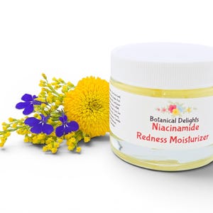 May include: A jar of Botanical Delights Niacinamide Redness Moisturizer with a white lid. The jar is next to a bouquet of yellow and blue flowers. The label on the jar has the product name and brand.