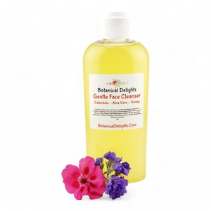 A bottle of "Balanced Delights" Gentle Face Cleanser, containing a yellow liquid, is surrounded by a few purple flowers.