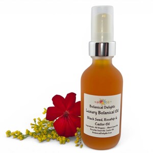 May include: A frosted glass bottle of Botanical Delights Luxury Botanical Oil. The bottle has a silver pump and contains a golden-orange liquid. A red flower and yellow sprigs are next to the bottle. The label reads "Black Seed, Rosehip & Castor Oil."