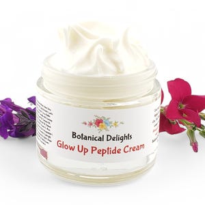 May include: A white jar of cream with a white swirl on top. The jar is labeled "Botanical Delights Glow Up Peptide Cream".