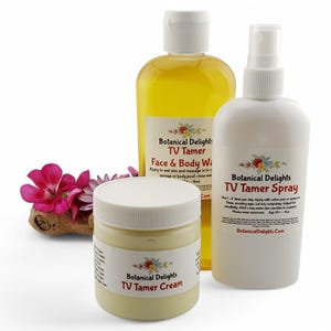 May include: Three white bottles with yellow and white labels. The bottles contain a face and body wash, a spray, and a cream. The labels all say "Botanical Delights TV Tamer".