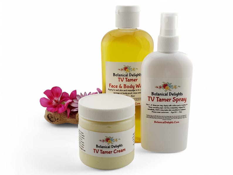 May include: Three white bottles with yellow and white labels. The bottles contain a face and body wash, a spray, and a cream. The labels all say "Botanical Delights TV Tamer".