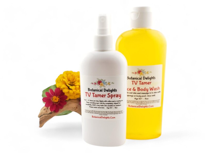 May include: Two white bottles with yellow liquid inside. The bottles are labeled "Botanical Delights TV Tamer Spray" and "Botanical Delights TV Tamer Face & Body Wash".