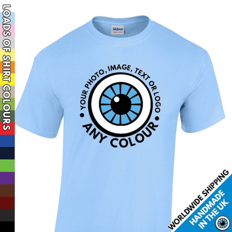May include: Light blue t-shirt with a white circle containing a blue eye graphic and the text "YOUR PHOTO, IMAGE, TEXT OR LOGO ANY COLOUR".