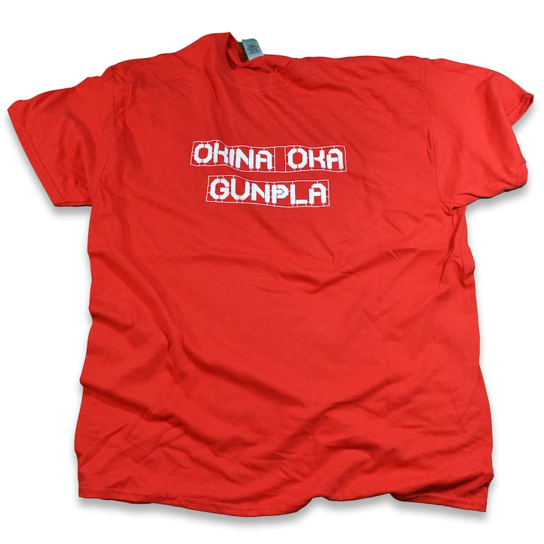 May include: Red t-shirt with white text that reads "OKINA OKA GUNPLA" in a pixelated font.