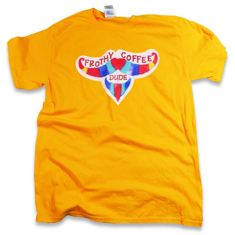 May include: A yellow t-shirt with a colorful graphic of a mustache with the text "Frothy Coffee Dude" above it.