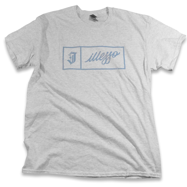 May include: A gray t-shirt with a blue rectangular box containing the text "illego" and a stylized letter "J".