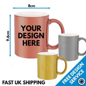 May include: A set of three metallic mugs in copper, gold, and silver finishes. The copper mug features the black text "YOUR DESIGN HERE" and has dimensions of 8cm in width and 9.6cm in height as indicated by the blue measurement arrows.